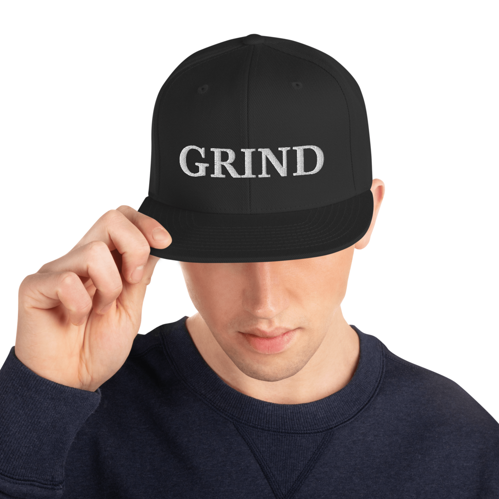 black "grind" snapback hat with white letters 