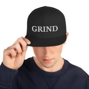 black "grind" snapback hat with white letters 