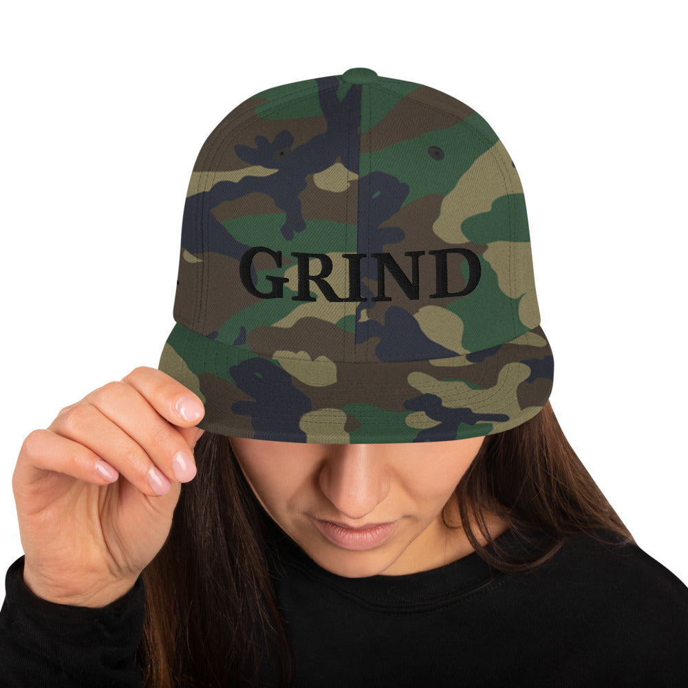 camo "grind" snapback hat with black letters 