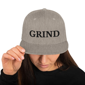 grey "grind" snapback hat with black letters  