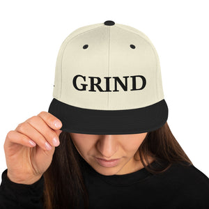 natural "grind" snapback hat with black letters and black brim